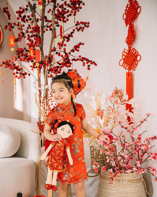 Child with a Chinese Mei cultural doll