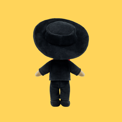 Back view of Mateo 🎸 wearing his traditional black Mariachi suit and oversized sombrero, celebrating family, music, and the warmth of shared culture and connection against a yellow background.