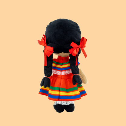 Back view of Xochitl 🌸 wearing her colorful Jalisco folklórico ribbon dress with flowing braided black hair tied in red ribbons, celebrating the beauty and tradition of Mexican folk dance against a peach background.