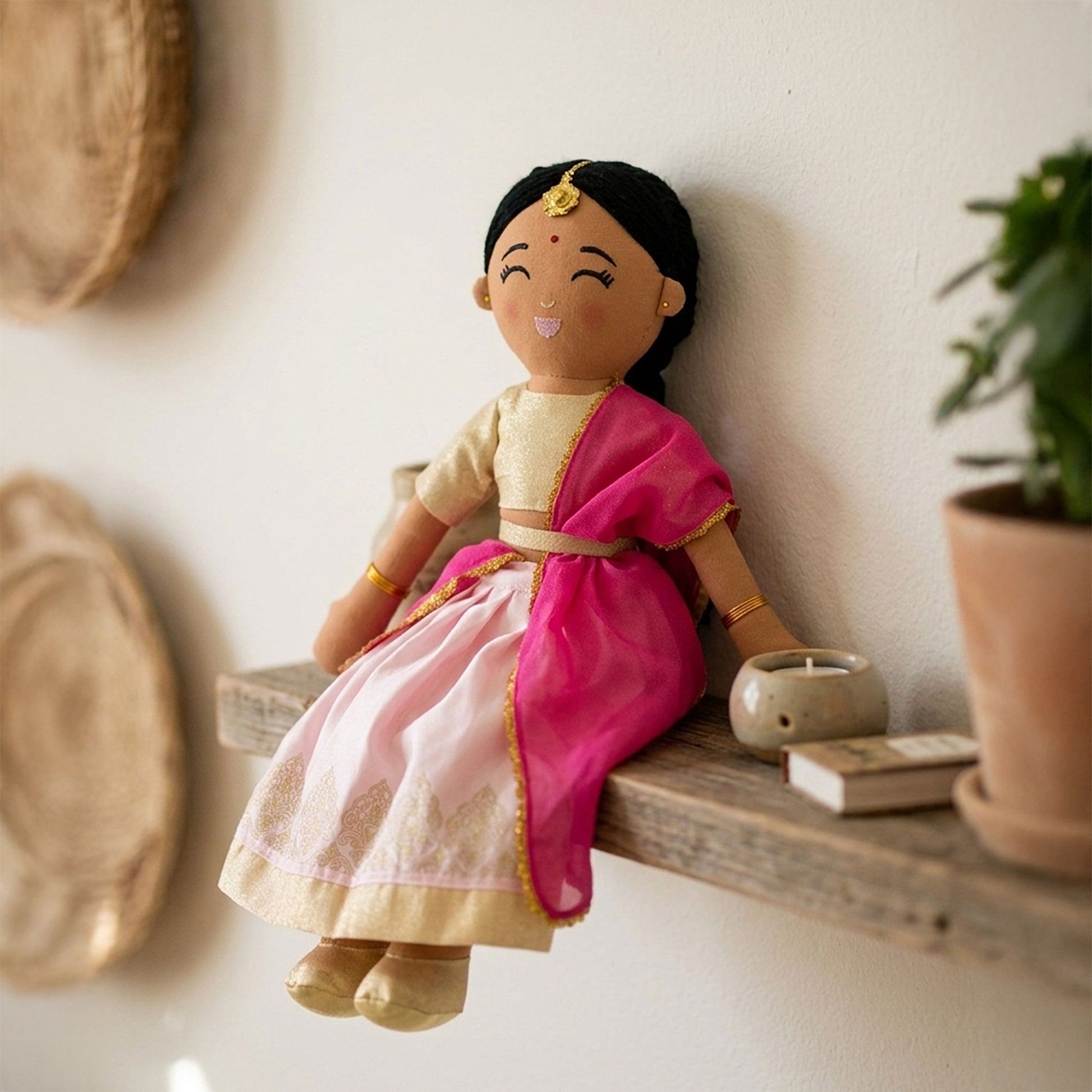 Close-up of Priya doll outfit featuring a gold choli and flowing pink dupatta