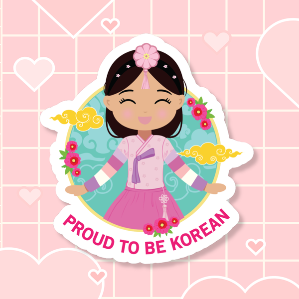 Proud to Be Korean die-cut sticker featuring a girl with long hair styled with a daenggi ribbon and jokduri headpiece, wearing an elegant pink hanbok with intricate details and a norigae ornament, set against a circular floral and patterned background with “Proud to Be Korean” text below.