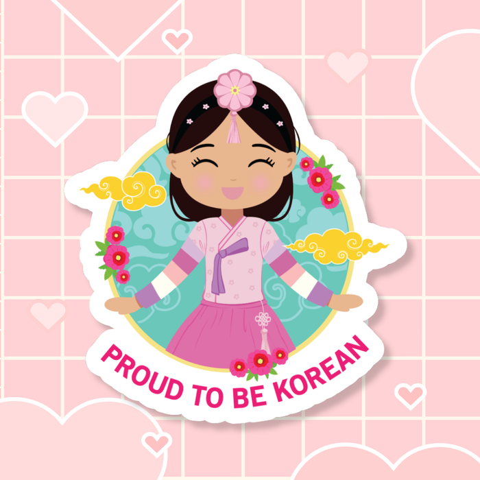 Proud to Be Korean die-cut sticker featuring a girl with long hair styled with a daenggi ribbon and jokduri headpiece, wearing an elegant pink hanbok with intricate details and a norigae ornament, set against a circular floral and patterned background with “Proud to Be Korean” text below.