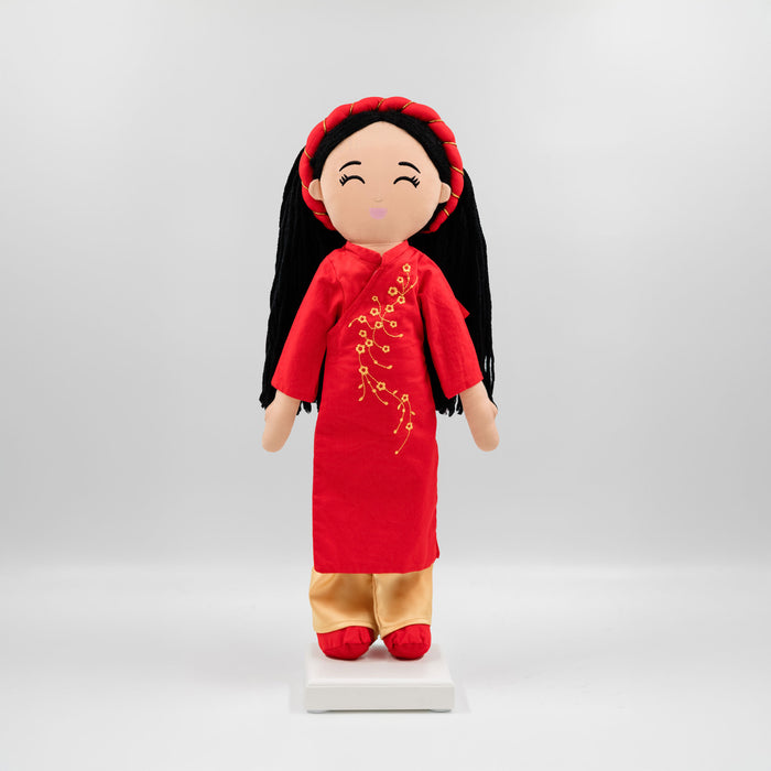 Hoa Vietnamese cultural doll wearing a red áo dài and khăn đóng.
