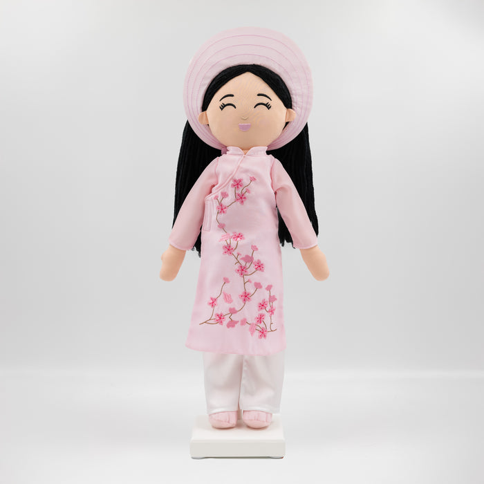 Thuong Vietnamese cultural doll wearing a red áo dài and khăn đóng