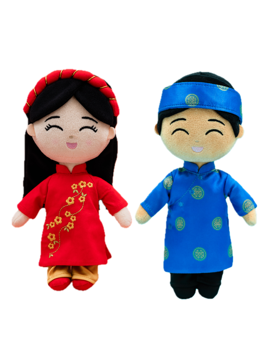 Vietnamese dolls, one in a red outfit with floral patterns and the other in a blue outfit with green circle patterns, on a white background.