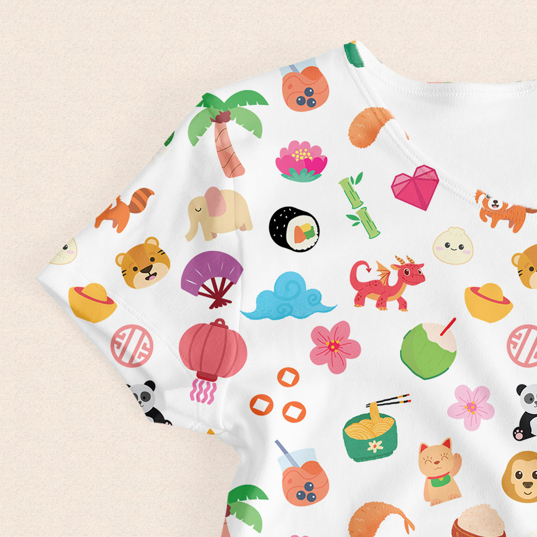 Asian Treasures women’s t-shirt close-up showing colorful icons including sushi, animals, flowers, and cultural elements.