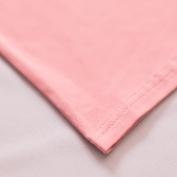 Proudly Asian baby onesie fabric detail showing soft pink cotton material with stitched hem.