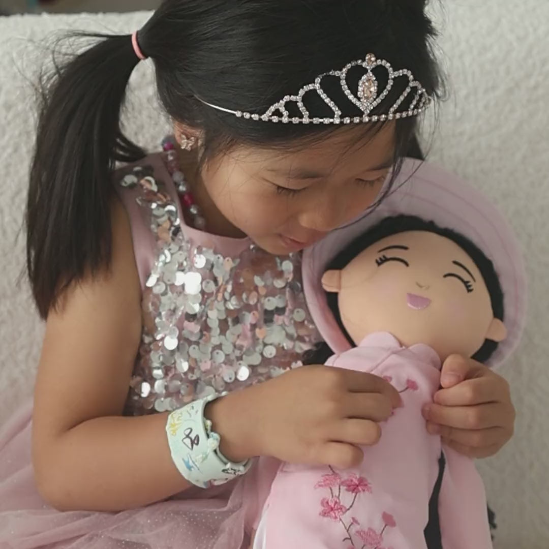 A girl hugging her Thương doll at Christmas