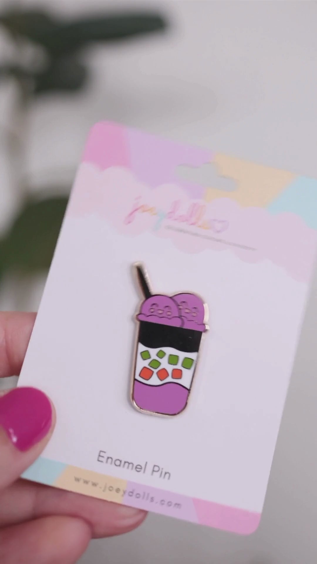 Halo-halo Filipino shaved ice dessert enamel pin on a Joeydolls display card, gently moving to show its two scoops of purple ice cream, layered dessert design, colorful toppings, and glossy finish.