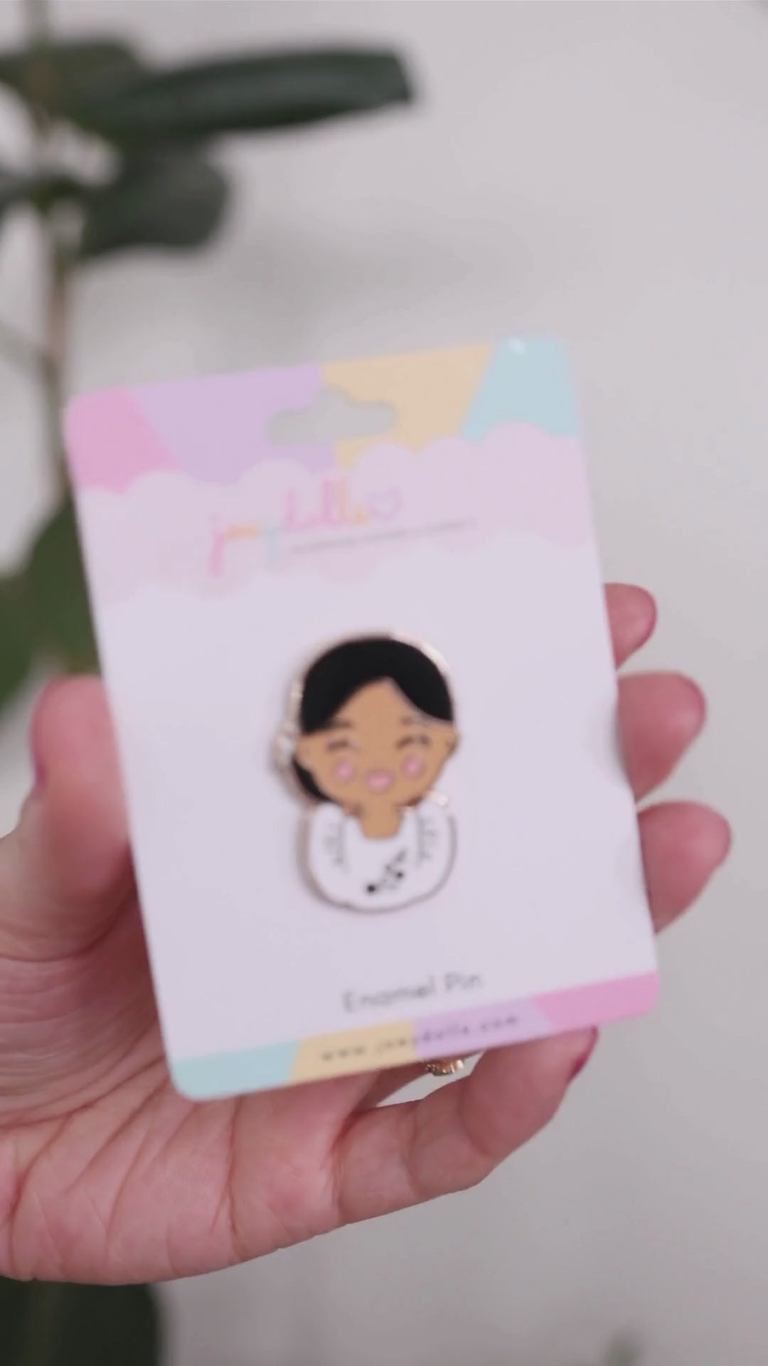 Joeydolls Filipina Malaya enamel pin on a Joeydolls display card, gently moving to show its Filipiniana dress details, butterfly sleeves, and glossy finish.