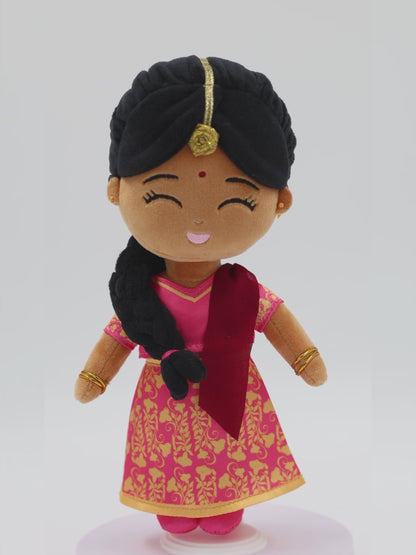 Front view of Priya Indian mini doll — 9” plush toy with pink and gold saree, red dupatta, and joyful expression, made for meaningful, imaginative play.