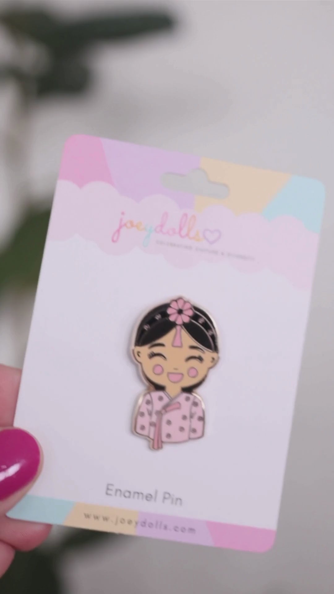 Joeydolls Korean Danbi gold enamel pin on branded packaging, featuring a smiling girl wearing a pink hanbok with ribbon accents and a traditional jokduri headpiece.